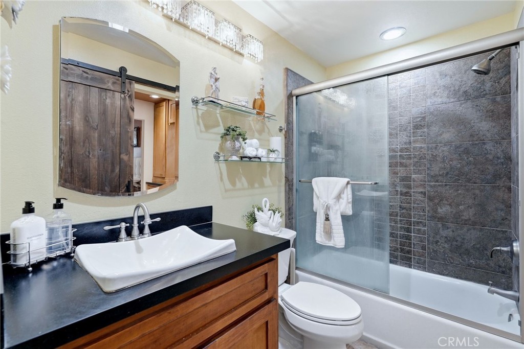7890 East Spring Street, Unit 2L Long Beach, CA 90815 - Photo 19 of 47 a bathroom with a sink a toilet and shower
