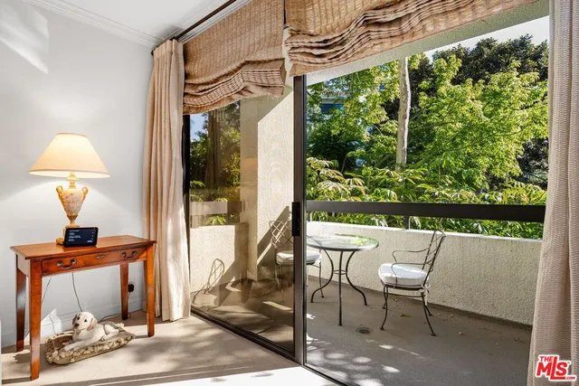 a dining room with furniture and a window