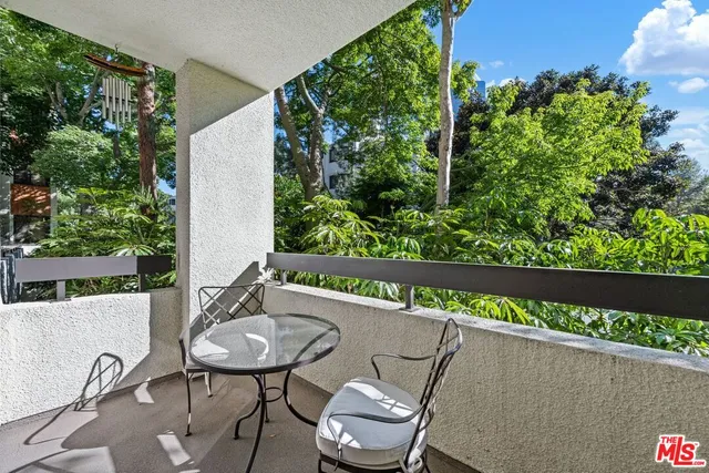 a view of a balcony with flower plants