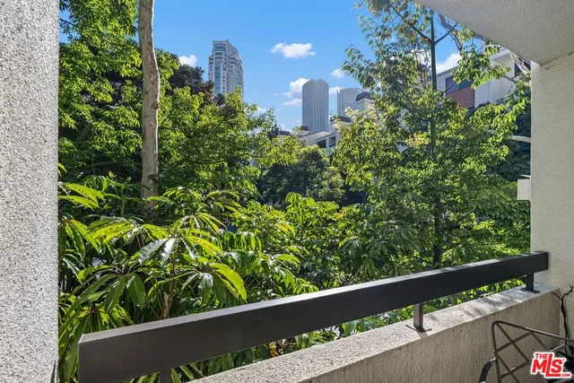 a dining room filled chandelier and wooden floor