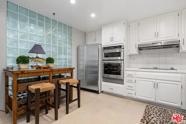 a kitchen with a sink cabinets and stainless steel appliances