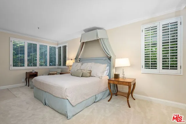 a bedroom with two beds and a lamp with window