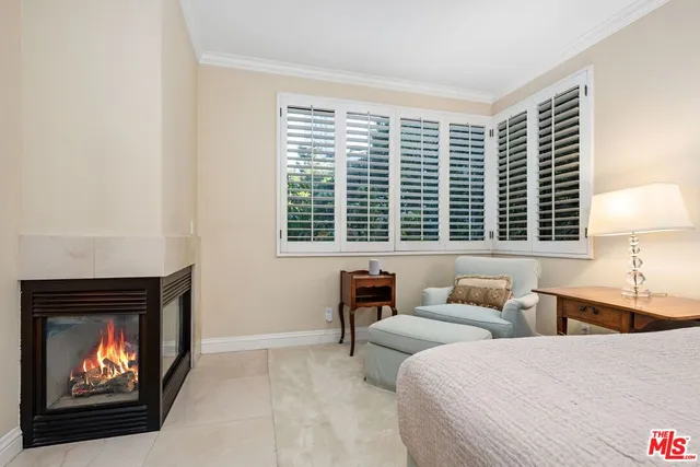 a bedroom with a bed and a fireplace