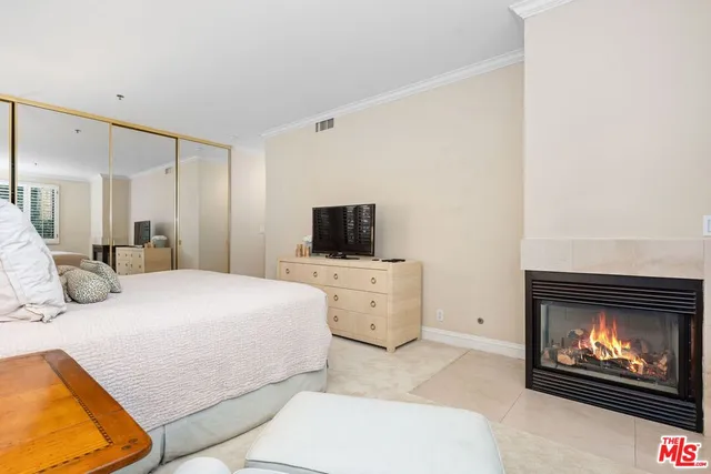 a view of a hallway with wooden floor and a bathroom