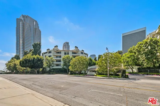 a view of a tall building next to a road