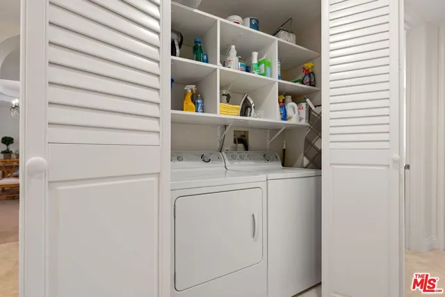 a white building with a yard and plants