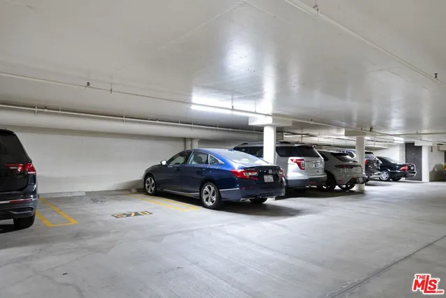a view of parking garage with cars