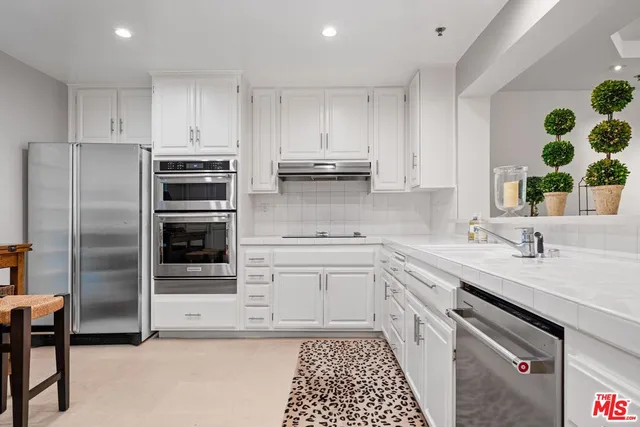 a kitchen with a sink stove and refrigerator