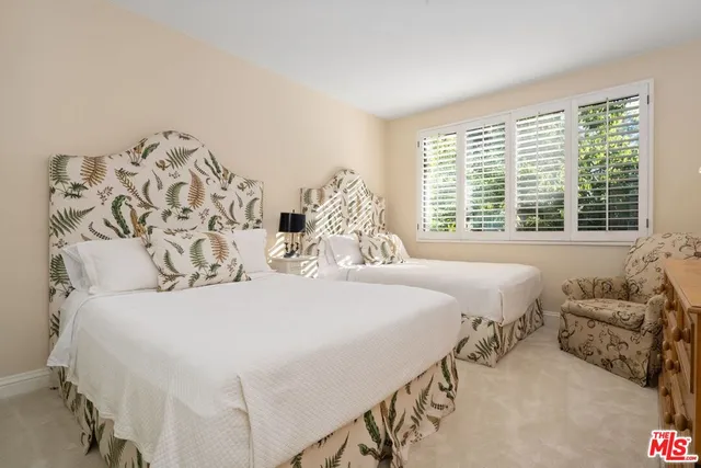 a bedroom with a large bed and a large window