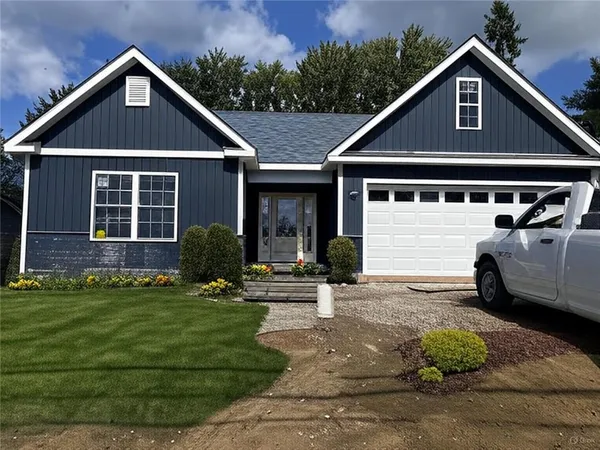 a front view of a house with a yard