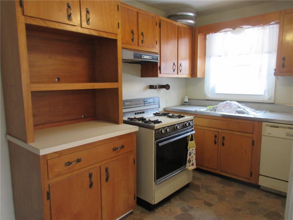 1491 Renton Road Pittsburgh, PA 15239 - Photo 3 of 15 a kitchen with granite countertop white cabinets and white appliances