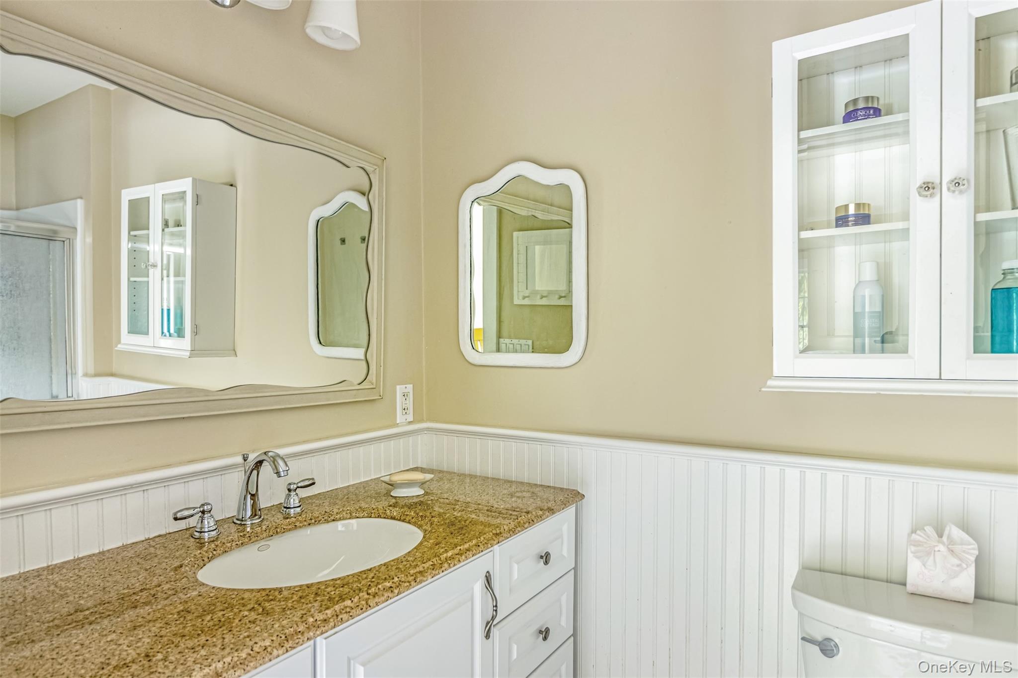 315 Wicks Road New Suffolk, NY 11956 - Photo 17 of 28 a bathroom with a granite countertop sink and a window
