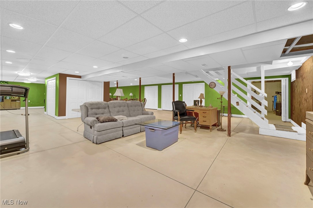 2690 Mayfair Road Akron, OH 44312 - Photo 26 of 31 Living area featuring a paneled ceiling, stairs, finished concrete flooring, a desk, and recessed lighting