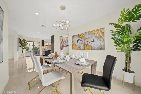 a view of a dining room with furniture wooden floor and a chandelier