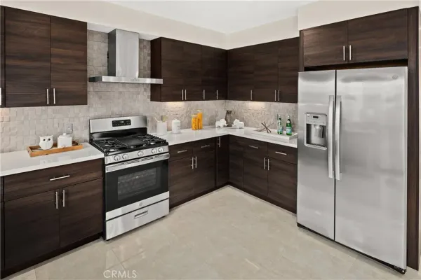 a kitchen with granite countertop a refrigerator and a stove