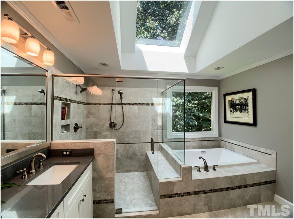 7908 Ogden Court Raleigh, NC 27613 - Photo 13 of 25 a bathroom with a tub a sink and window