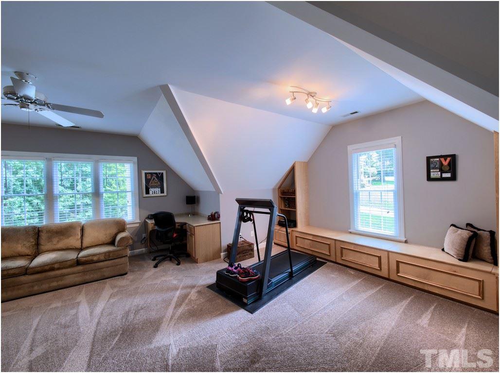 7908 Ogden Court Raleigh, NC 27613 - Photo 20 of 25 a living room with furniture gym equipment and a large window