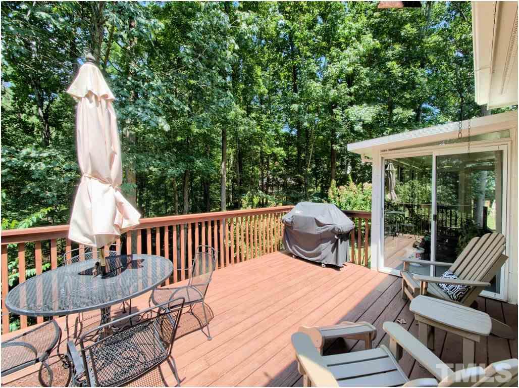 7908 Ogden Court Raleigh, NC 27613 - Photo 23 of 25 a view of a patio with table and chairs and wooden floor