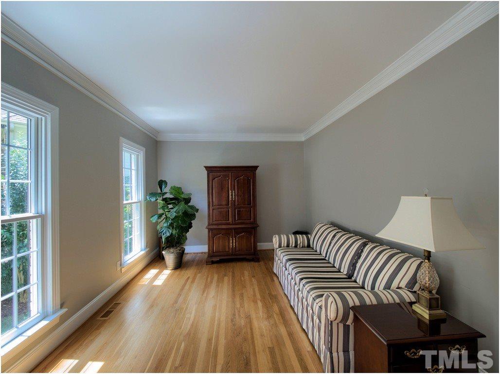 7908 Ogden Court Raleigh, NC 27613 - Photo 4 of 25 a bedroom with a bed and a potted plant