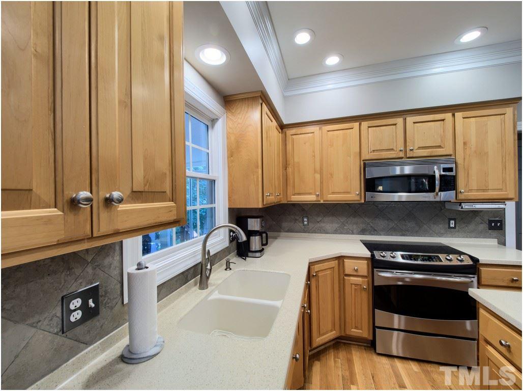 7908 Ogden Court Raleigh, NC 27613 - Photo 5 of 25 a kitchen with kitchen island granite countertop a sink cabinets and stainless steel appliances