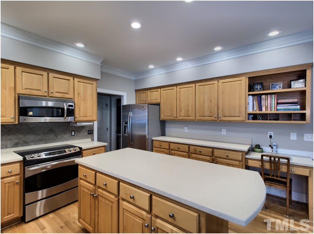 7908 Ogden Court Raleigh, NC 27613 - Photo 6 of 25 a kitchen with stainless steel appliances a stove refrigerator sink and cabinets