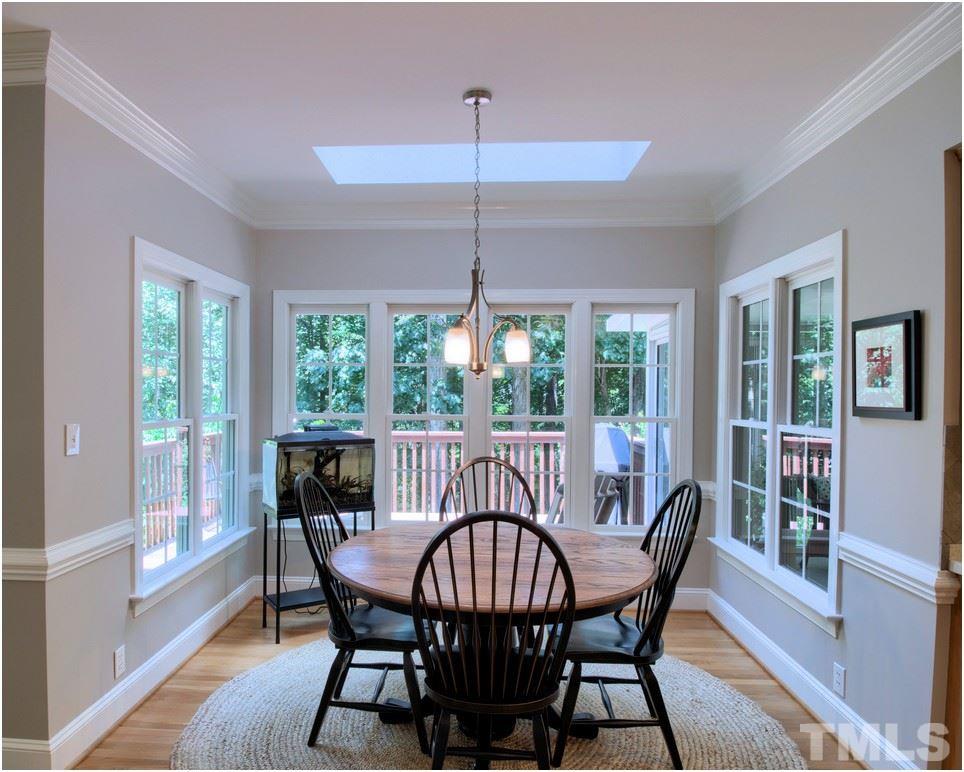 7908 Ogden Court Raleigh, NC 27613 - Photo 7 of 25 a view of a dining room with furniture window and wooden floor