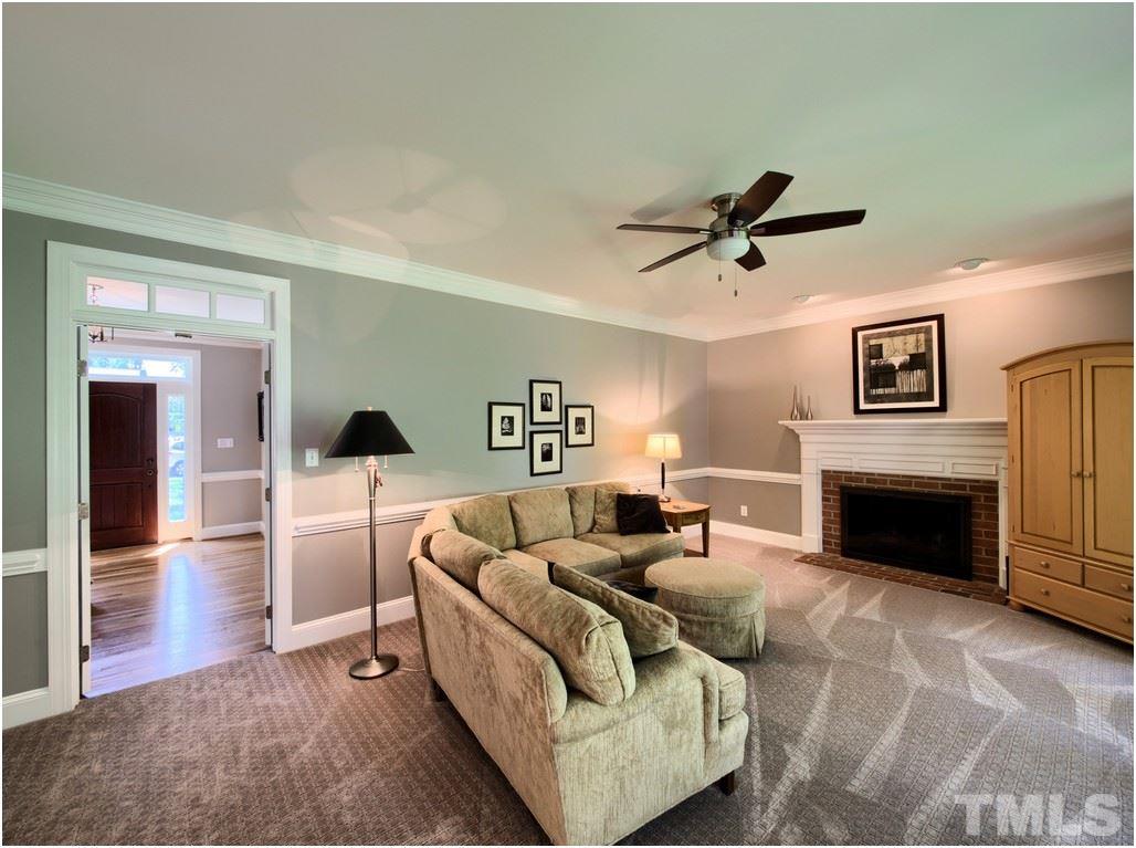 7908 Ogden Court Raleigh, NC 27613 - Photo 8 of 25 a living room with furniture and a fireplace