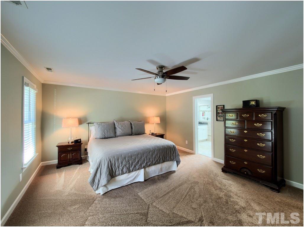 7908 Ogden Court Raleigh, NC 27613 - Photo 10 of 25 a bedroom with a bed and a cabinets