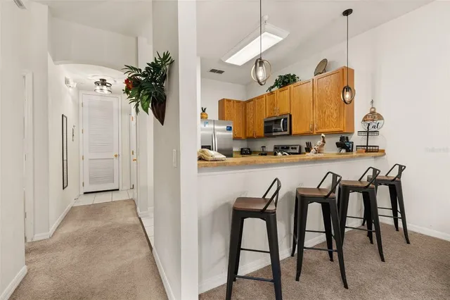 a living room with furniture a flat screen tv and floor to ceiling window