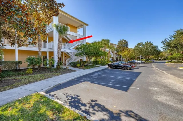 a street view with a building and trees in the background
