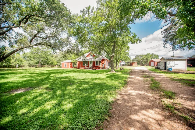 a view of yard with tree and wooden fence