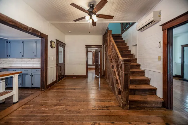 a living room with wooden floors and a window