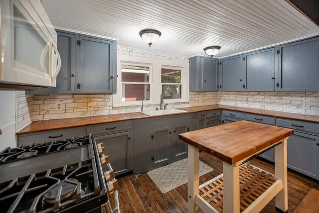 a kitchen with stainless steel appliances granite countertop a sink and stove