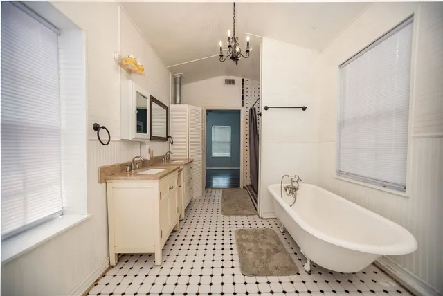 a bathroom with a black white checkered floor