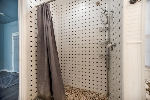a view of a room with wooden floor and a ceiling fan