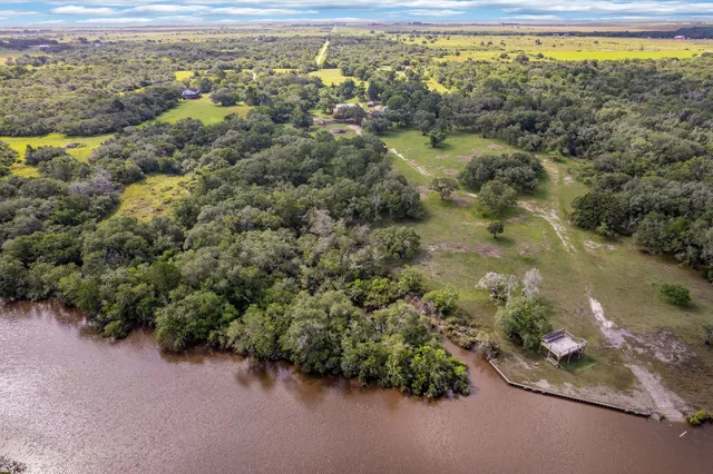 an aerial view of a houses with a yard