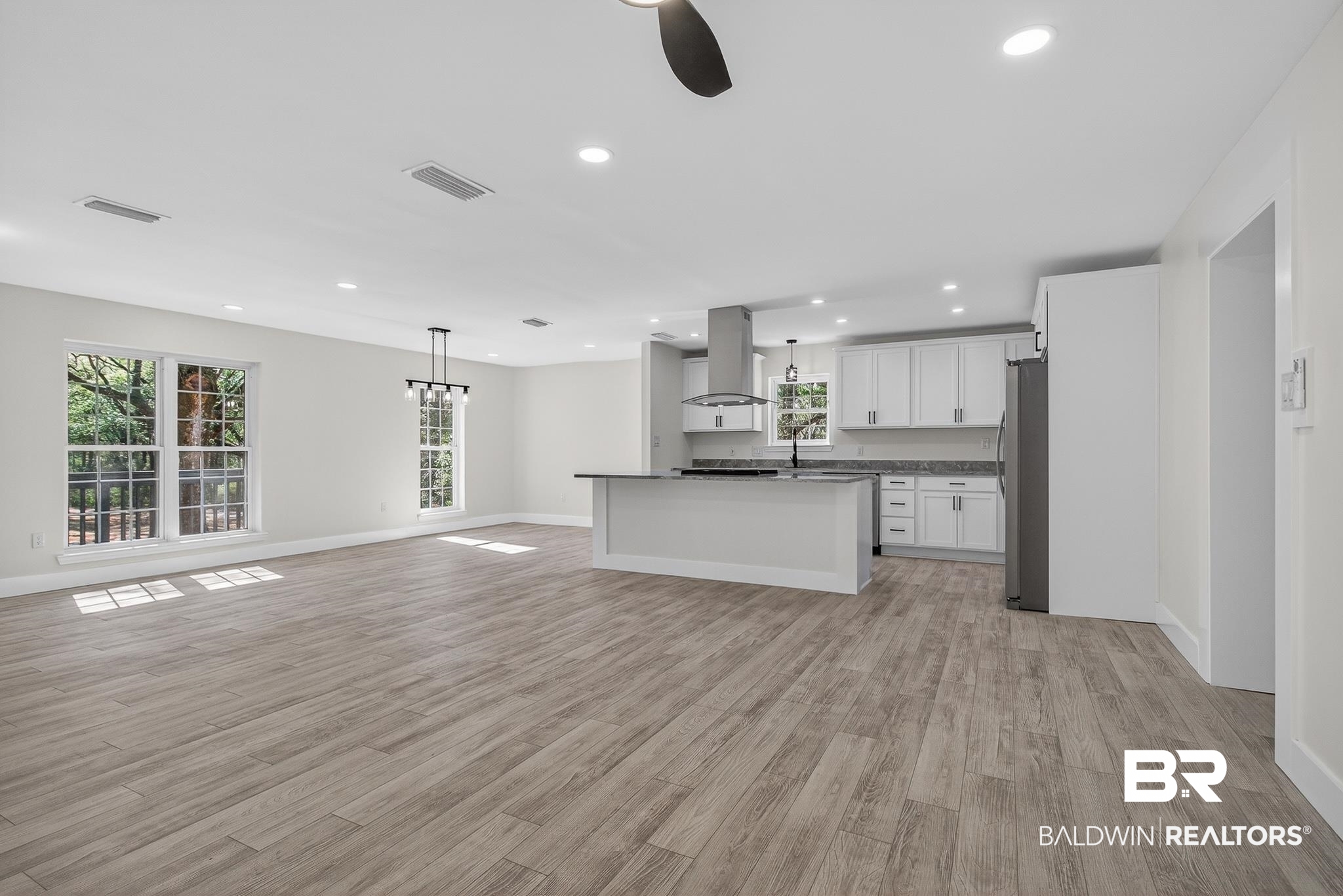 10650 Old Pascagoula Road Theodore, AL 36582 - Photo 76 of 77 Kitchen featuring open floor plan, dark countertops, white cabinetry, ceiling fan, and light wood-style flooring