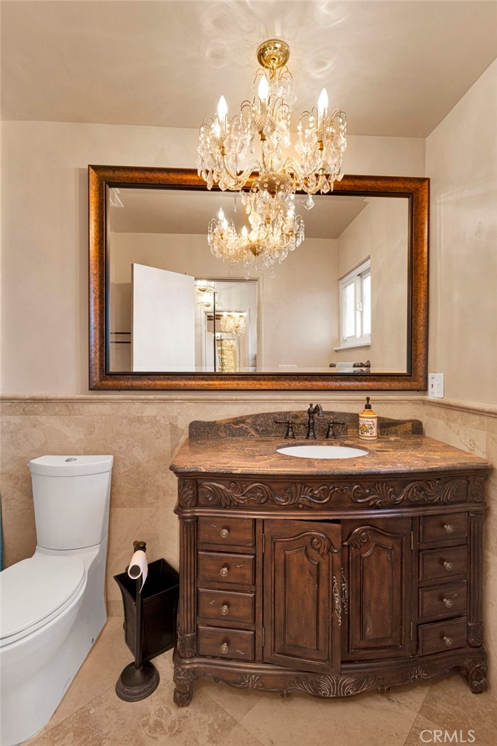 15177 Mendota Road North Apple Valley, CA 92307 - Photo 18 of 50 a bathroom with a granite countertop sink a large mirror and a toilet