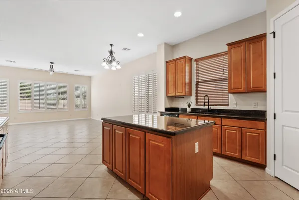 a kitchen with stainless steel appliances granite countertop a sink and a stove