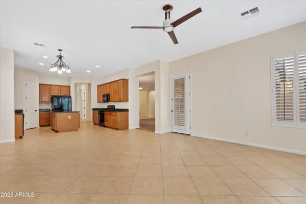 a living room with furniture and kitchen view