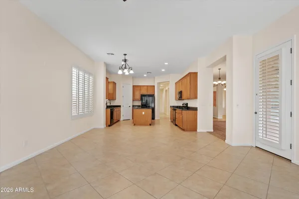 a view of a big room with windows and chandelier