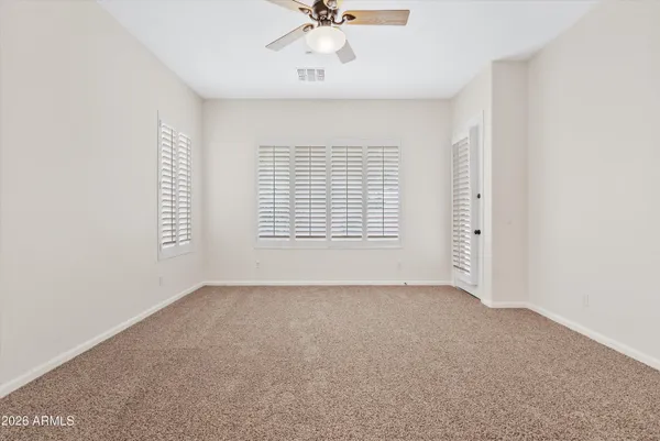 an empty room with windows and closet