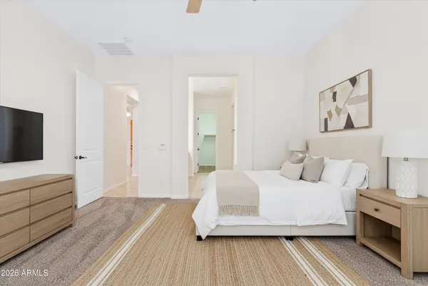 a bedroom with a bed and a flat screen tv