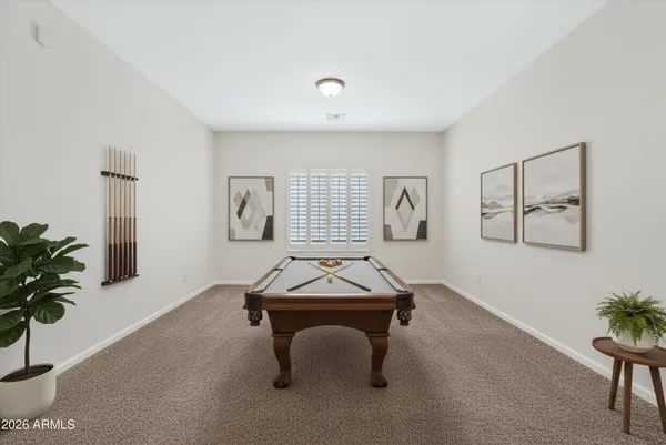 a room with pool table and windows