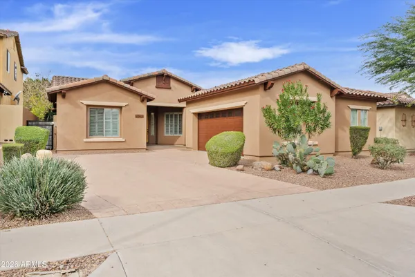 a view of a house with a yard and potted plants