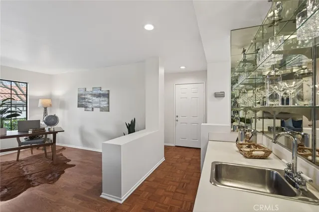 a living room with furniture and a sink