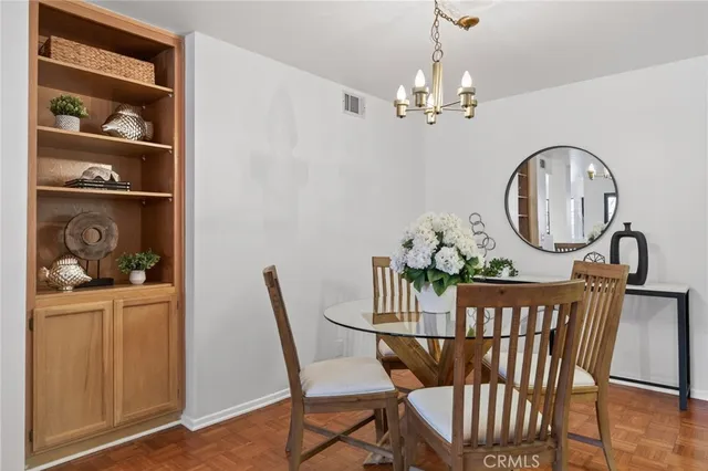 a view of a dining room with furniture and chandelier