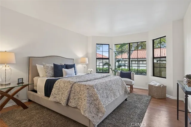 a bedroom with a bed and glass window
