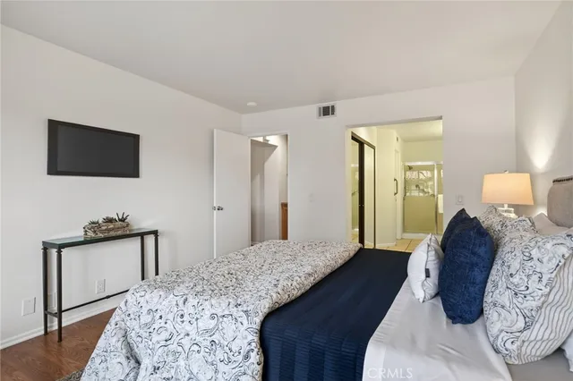 a bedroom with a bed and a flat screen tv