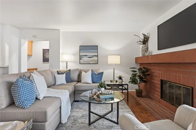 a living room with furniture a fireplace and a flat screen tv